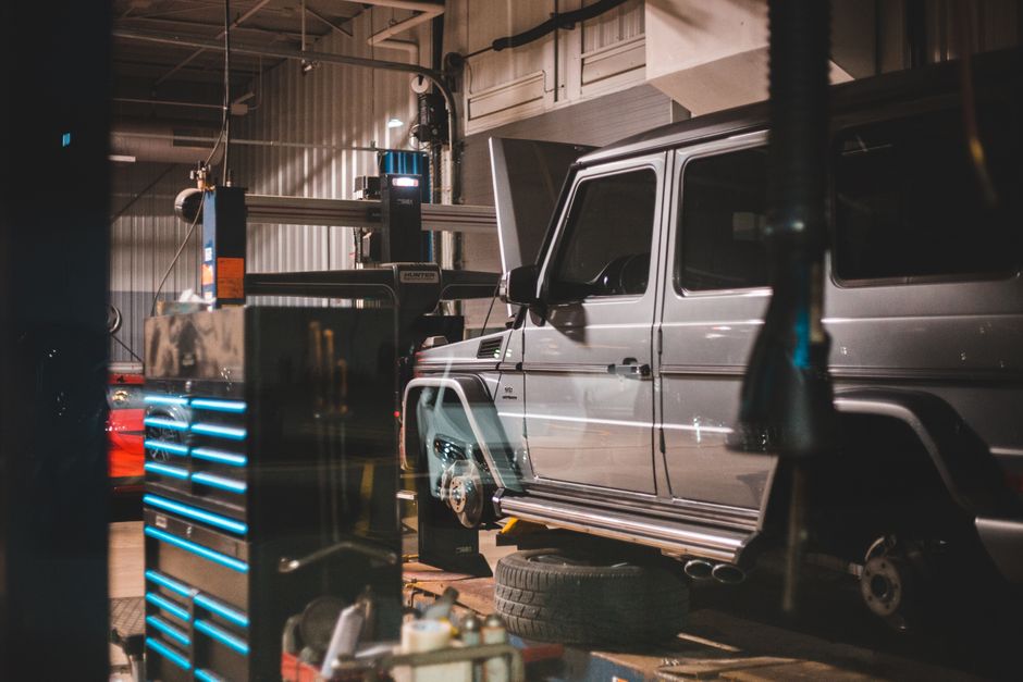 Contemporary automobile on repair in spacious garage with metal details and fixing parts